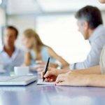 Girl writes in a notebook at the table