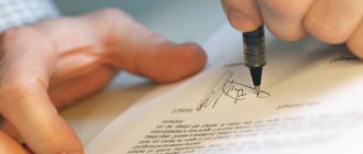 A man puts his signature on a document